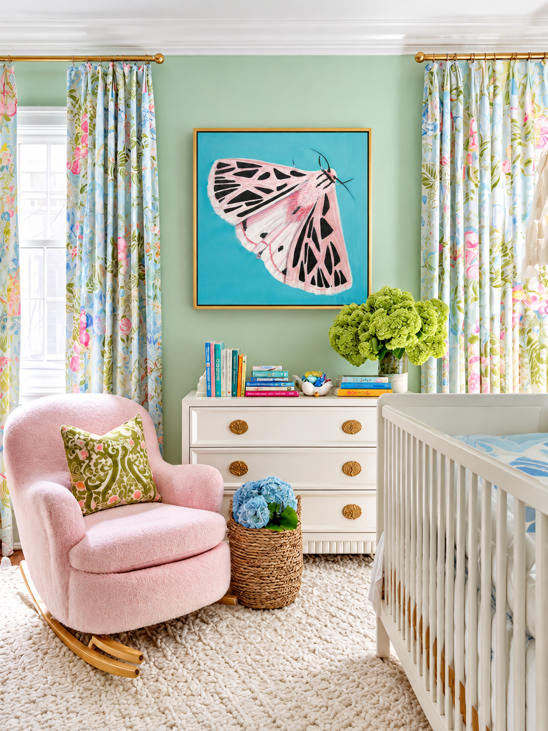Fortitude pink-and-black moth painting on a turquoise ground in a gold floating frame in a mint green nursery